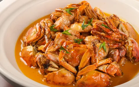 Pieces of crab coated in a reddish sauce