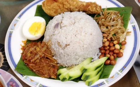 Nasi lemak with coconut rice, fried chicken, sambal, peanuts and egg