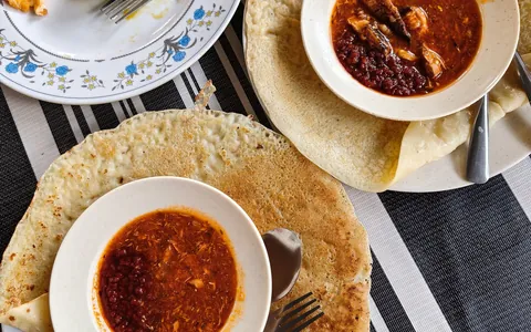 Flaky roti canai flatbreads served with curry